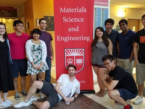 Group of students with Rutgers Materials Science and Engineering retractable red and white banner. 